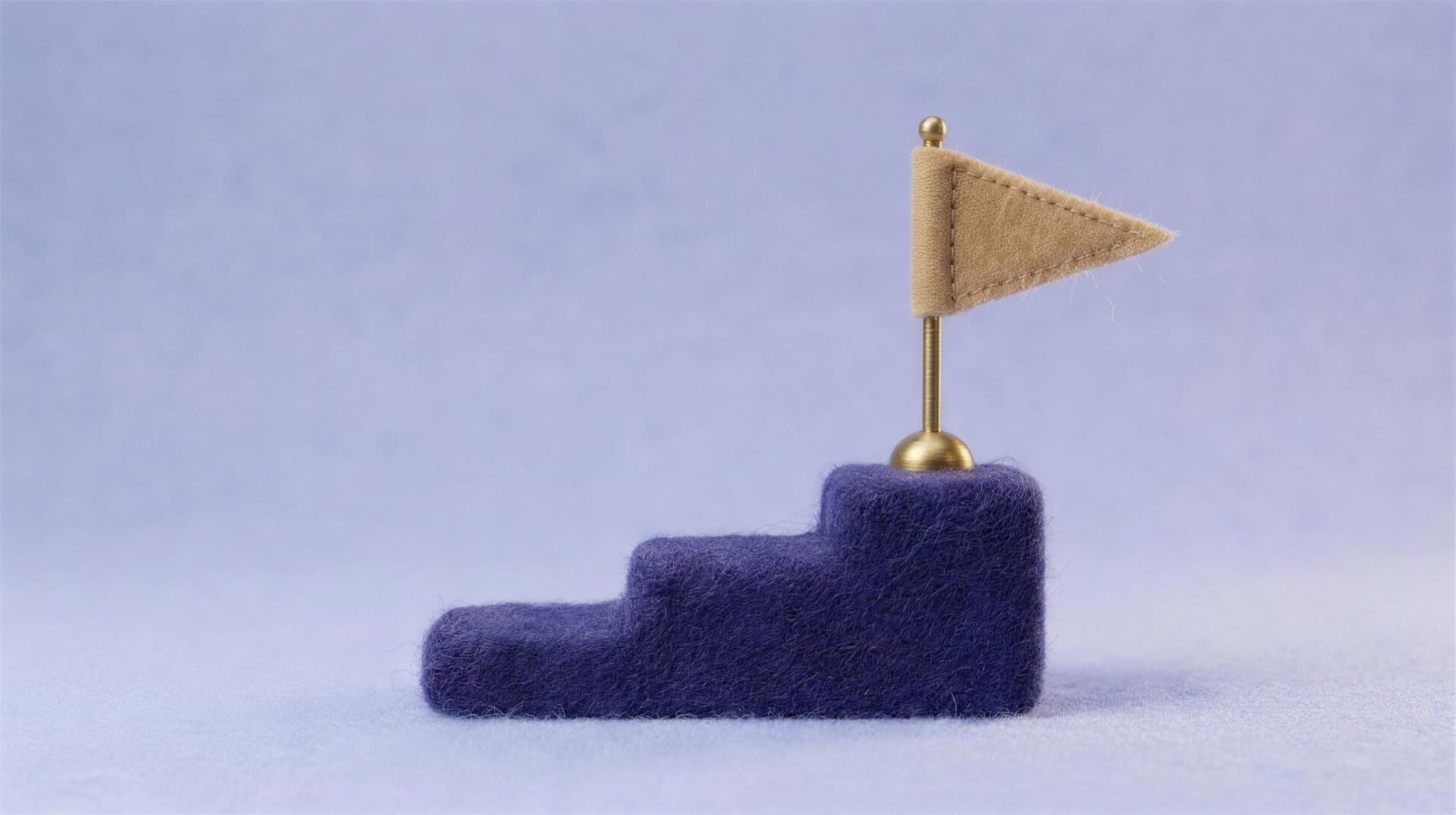 A tan felt pennant flag planted on top of an indigo felt podium