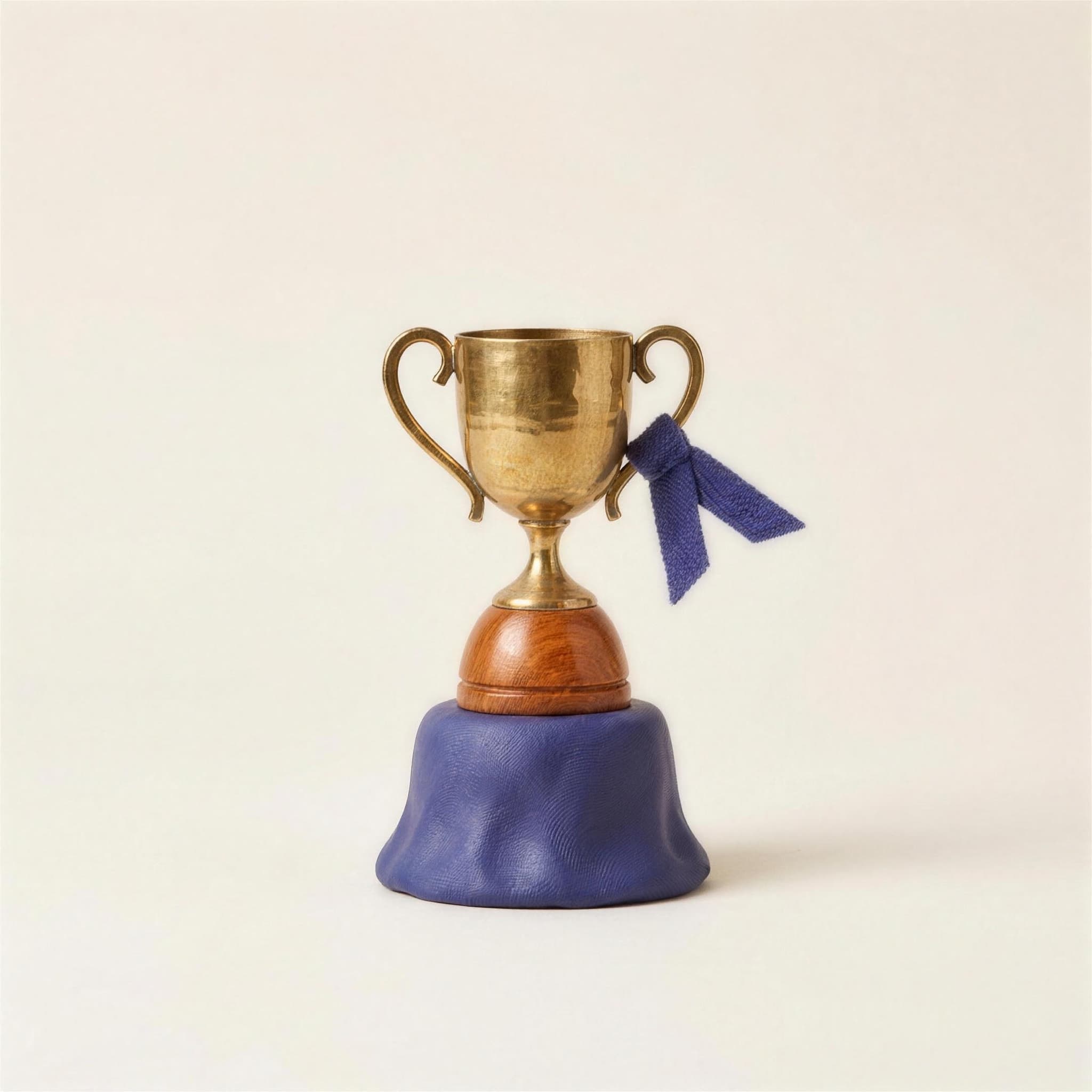 A felted golden trophy on an indigo felt base